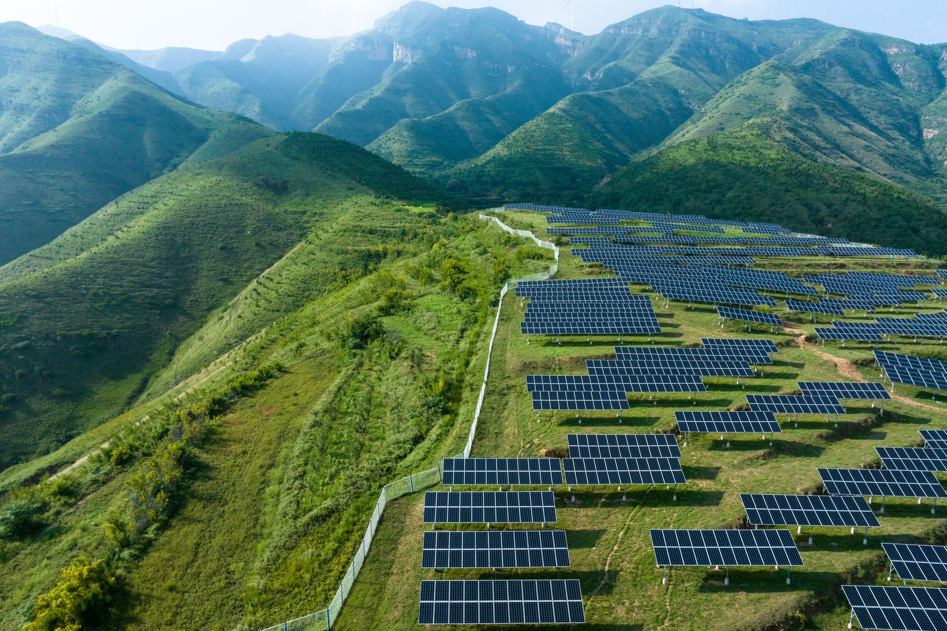 view of solar power station on green hill
