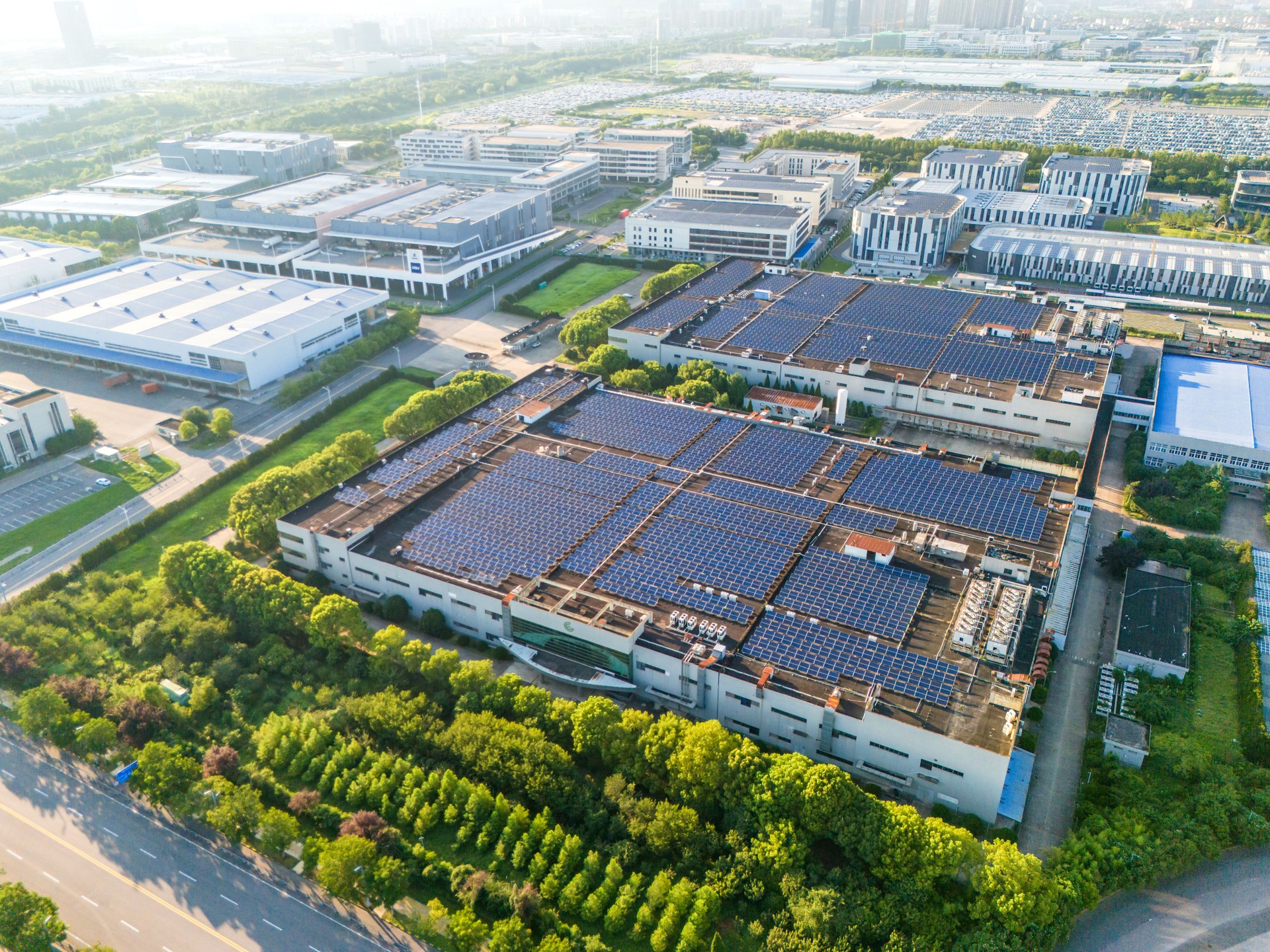 Solar panels mounted on factory roof for producing green ecological electricity